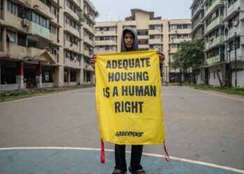 Razan Marunda Flats youth holds a banner reads "Adequate Housing is a Human Right" at the field of Marunda Flats Cluster A building in Marunda, North Jakarta. As a center for government and economic activity, Jakarta has always been grappling with millions of problems. Traffic and public transportation may have become the city’s most infamous problems, but the city also grapples with other issues including jobs, waste, and now, the climate crisis. 
The local government tries to address most of those issues, but many are still left unsolved and even neglected. 
Outskirts area like Marunda, North Jakarta, have been left to their own devices to tackle their problems such as unemployment, housing, and air pollution due to coal dust from the nearby stockpile. Residents of Marunda Flats demanded the Jakarta government to provide an alternative and clean energy source, in which they have long been the victims of air pollution from the nearby coal-fired power plants.