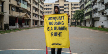 Razan Marunda Flats youth holds a banner reads "Adequate Housing is a Human Right" at the field of Marunda Flats Cluster A building in Marunda, North Jakarta. As a center for government and economic activity, Jakarta has always been grappling with millions of problems. Traffic and public transportation may have become the city’s most infamous problems, but the city also grapples with other issues including jobs, waste, and now, the climate crisis. 
The local government tries to address most of those issues, but many are still left unsolved and even neglected. 
Outskirts area like Marunda, North Jakarta, have been left to their own devices to tackle their problems such as unemployment, housing, and air pollution due to coal dust from the nearby stockpile. Residents of Marunda Flats demanded the Jakarta government to provide an alternative and clean energy source, in which they have long been the victims of air pollution from the nearby coal-fired power plants.