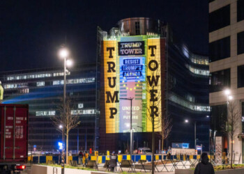 Activists project a golden facade and the words “TRUMP TOWER” onto the European Commission headquarters in Brussels